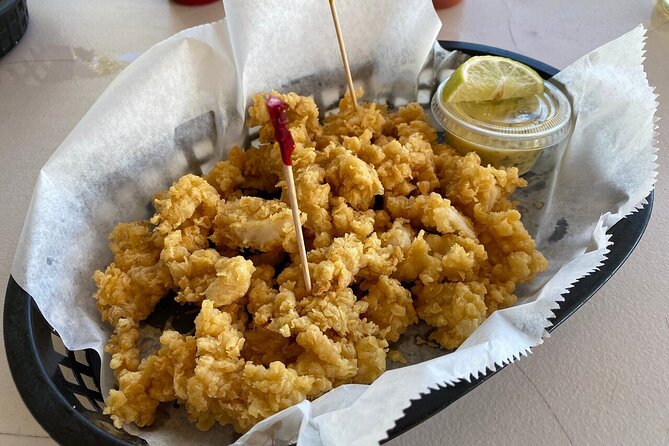 Bimini Island Food Taste Experience Tour - Stuart’s Conch Stand offers a drink by the beach