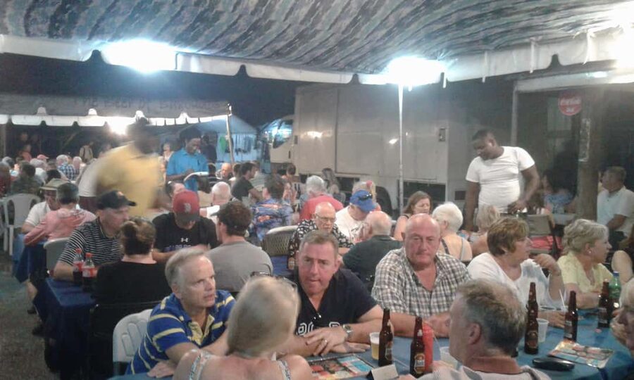 Bridgetown: Oistins reservation with drink & return transfer - A reserved table and one welcome drink