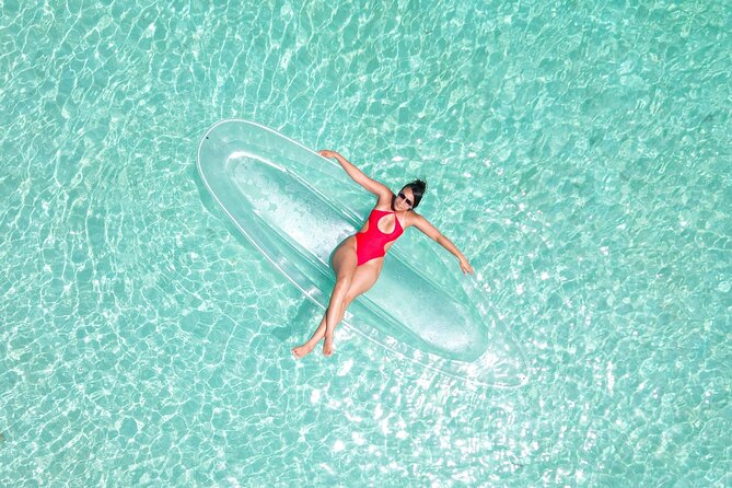Crystal Clear Kayak Drone Photography Antigua - Getting settled in the transparent kayak