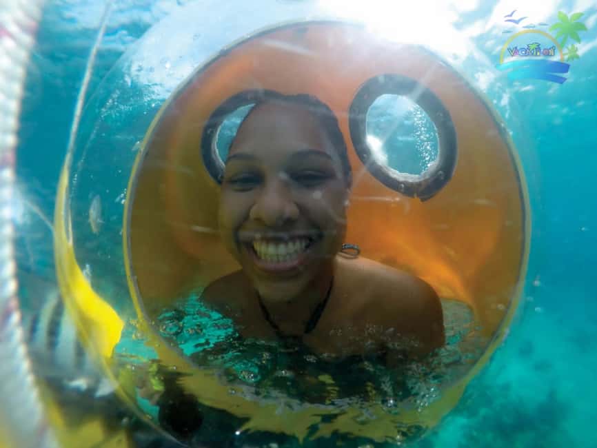 From Punta Cana: ScubaDoo, Snorkel & Glass Bottom Boat Tour - Boarding the boat at the coastal platform